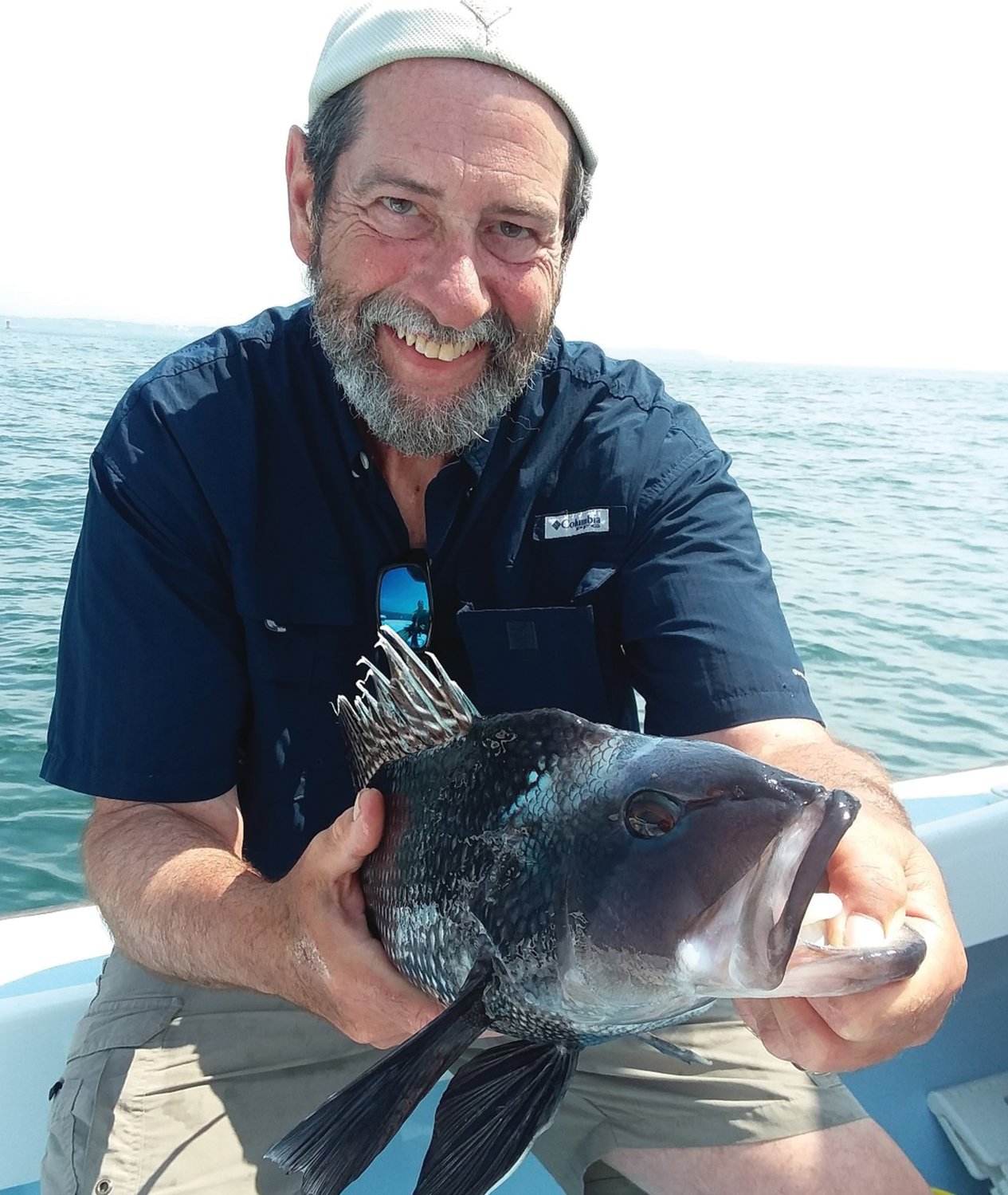 SEA BASS WITH ATTITUDE: Capt. Dave Monti with a black sea bass caught three miles south of the Sakonnet River.